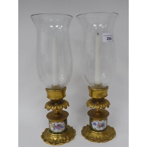 284 - A pair of modern antique French reproduction porcelain cast gilt brass and glazed candlesticks  13.5... 