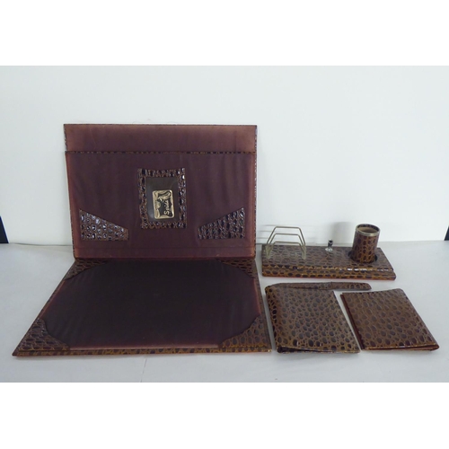 291 - A modern crocodile skin effect desk set, comprising a desk tidy, a blotter, letter knife and folders