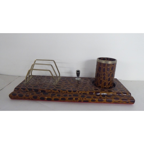 291 - A modern crocodile skin effect desk set, comprising a desk tidy, a blotter, letter knife and folders