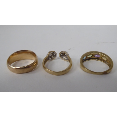 294 - Three 9ct gold rings, one set with a band of multi-coloured stones 