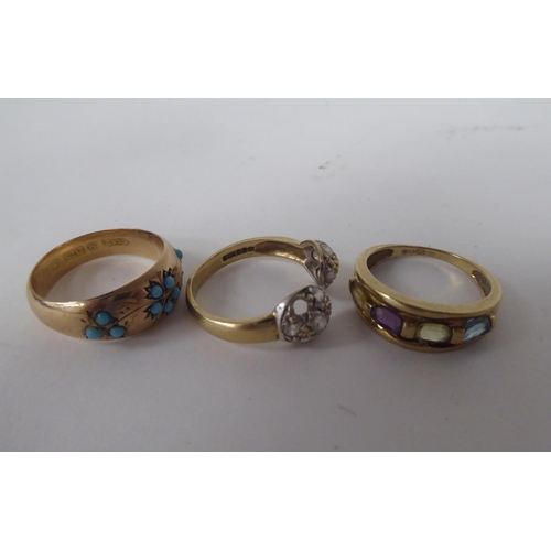 294 - Three 9ct gold rings, one set with a band of multi-coloured stones 