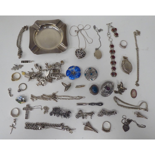 300 - Silver and white metal jewellery: to include a charm bracelet; and various broochs 