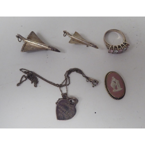 300 - Silver and white metal jewellery: to include a charm bracelet; and various broochs 