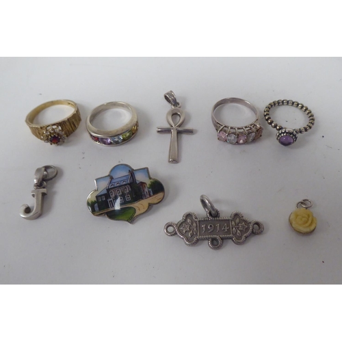 300 - Silver and white metal jewellery: to include a charm bracelet; and various broochs 