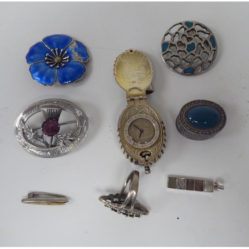 300 - Silver and white metal jewellery: to include a charm bracelet; and various broochs 