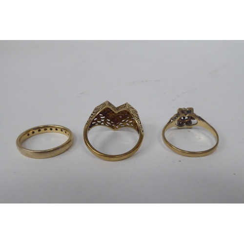 306 - Three 9ct gold rings, one with purple stones, fashioned as a heart