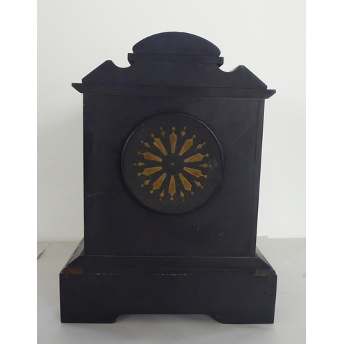 324 - A late Victorian black slate mantel clock of architectural form; the 8 day movement faced by a Roman... 