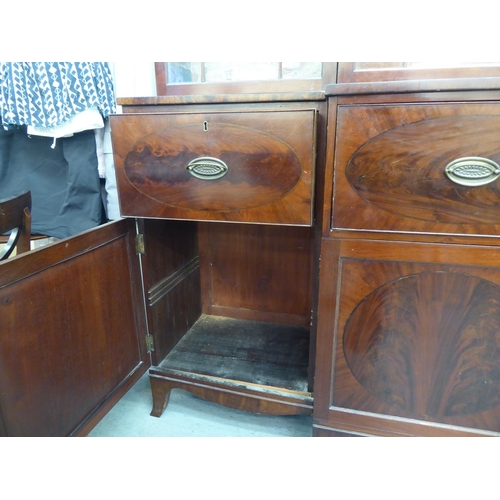 326 - A 19thC mahogany breakfront library bookcase with a blind fret carved cornice, over four ecclesiasti... 