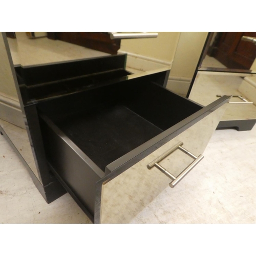 327 - A pair of modern mirrored two drawer bedside cabinets, raised on bracket feet  21