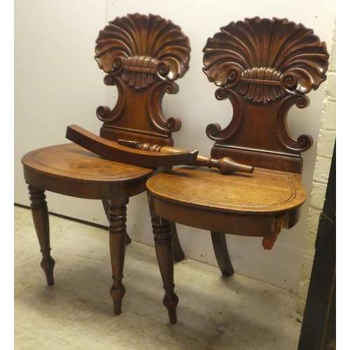 328 - A pair of William IV mahogany hall chairs, the shell and twin C-scrolled back, over a solid seat, ra... 