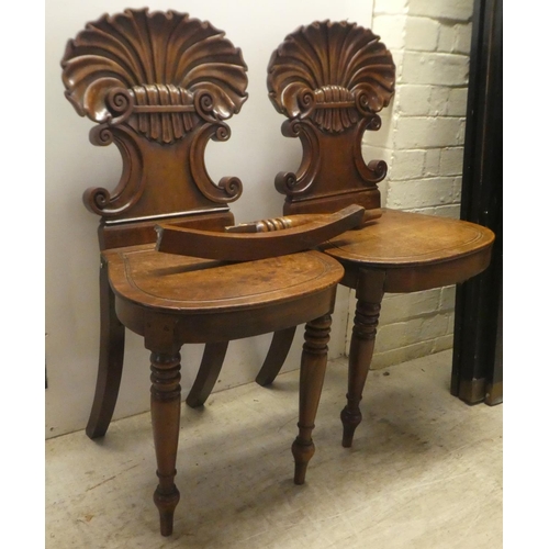 328 - A pair of William IV mahogany hall chairs, the shell and twin C-scrolled back, over a solid seat, ra... 