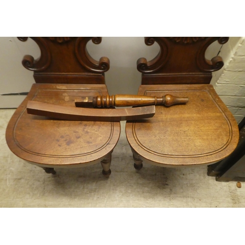 328 - A pair of William IV mahogany hall chairs, the shell and twin C-scrolled back, over a solid seat, ra... 