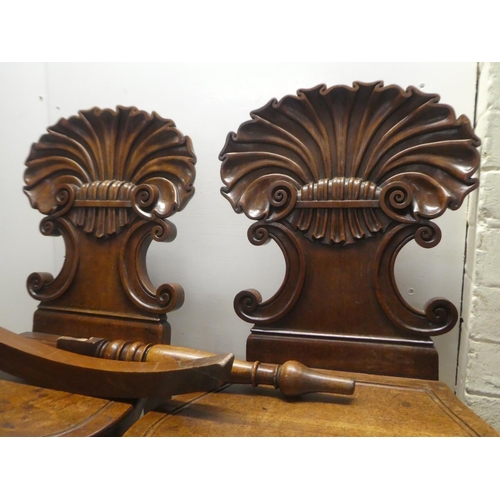 328 - A pair of William IV mahogany hall chairs, the shell and twin C-scrolled back, over a solid seat, ra... 