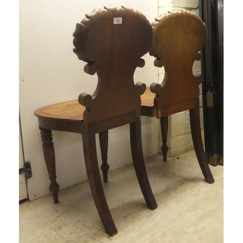 328 - A pair of William IV mahogany hall chairs, the shell and twin C-scrolled back, over a solid seat, ra... 