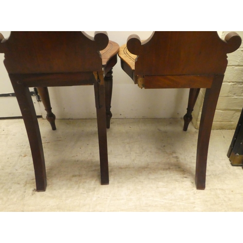 328 - A pair of William IV mahogany hall chairs, the shell and twin C-scrolled back, over a solid seat, ra... 