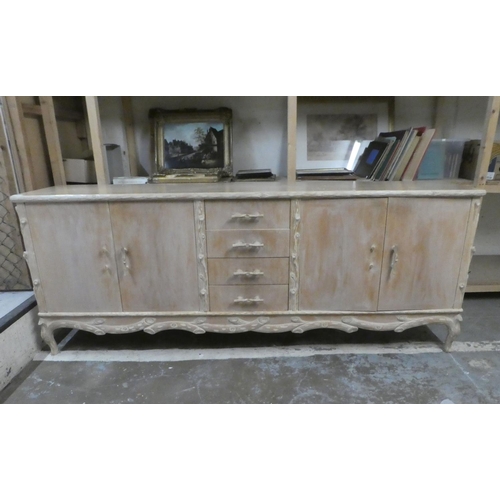 332 - A modern French hunting lodge style, naturally carved, bleached light oak sideboard with a central b... 