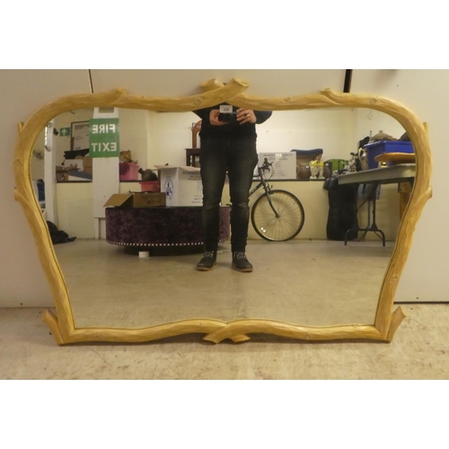 335 - A modern French hunting lodge style, naturally carved, bleached light oak framed mirror  35