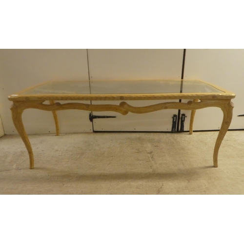 337 - A modern French hunting lodge style, naturally carved, bleached light oak framed coffee table with a... 