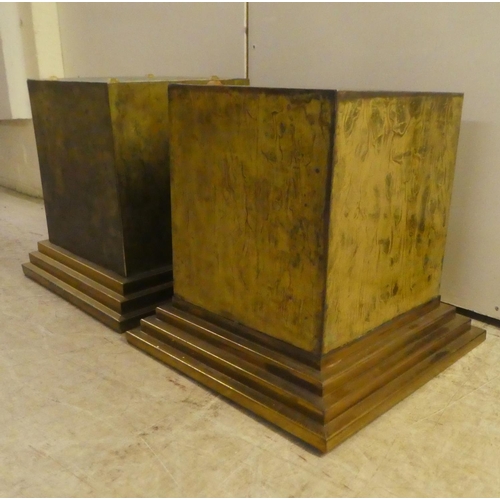 343 - A pair of Art Deco inspired cast metal pedestals, on a stepped plinth  18