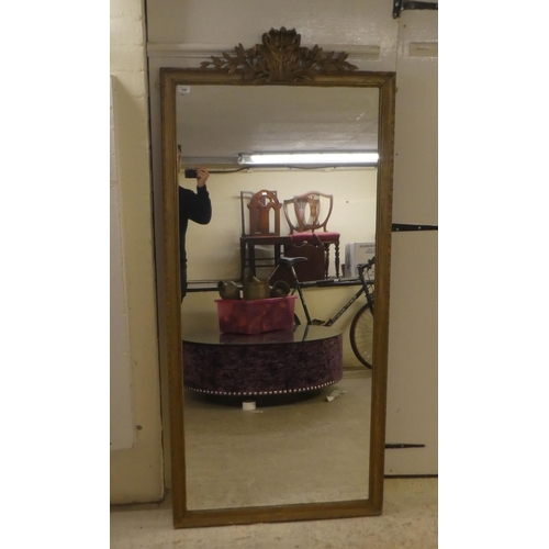 346 - A late 19thC mirror, the plate set in a carved and moulded gilt frame  62