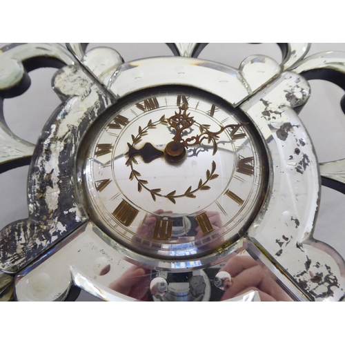 348 - A mid 20thC Venetian design, mirrored panelled wall timepiece; the Garrard movement faced by a Roman... 