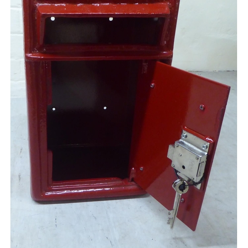 40 - A reproduction wall mounted, red painted, cast iron Royal Mail postbox  17