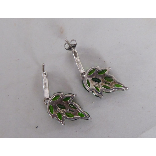 87 - A pair of white metal earrings, fashioned as leaves, set with green stones  stamped 925