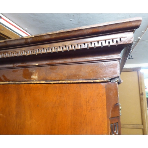 105 - A George III mahogany chest-on-chest with a broken arch cornice and Greek Key style dentil moulding,... 