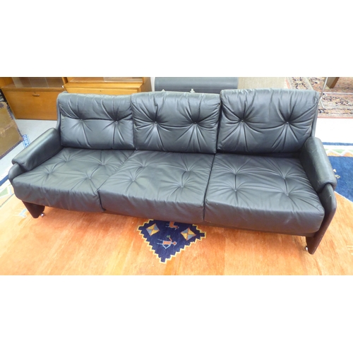 106 - A modern Pirelli moulded stitched black hide upholstered three person low back settee with enclosed ... 