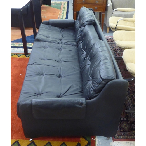 107 - A modern Pirelli moulded stitched black hide upholstered three person low back settee with enclosed ... 