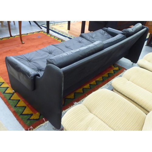 107 - A modern Pirelli moulded stitched black hide upholstered three person low back settee with enclosed ... 