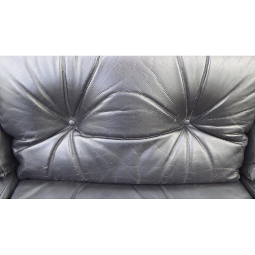 107 - A modern Pirelli moulded stitched black hide upholstered three person low back settee with enclosed ... 