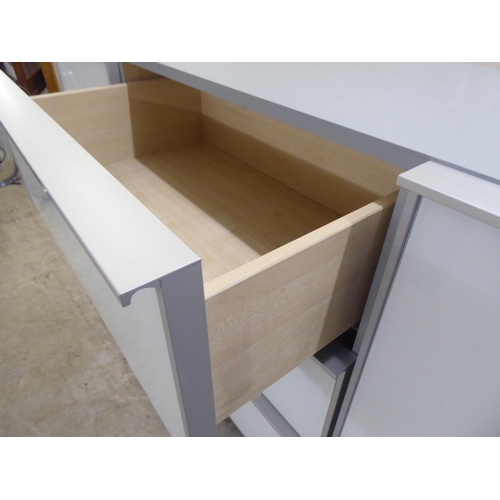111 - A modern white and grey laminate and satin silver coloured metal mounted sideboard, comprising a ban... 