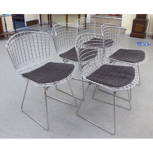 139 - A set of five Bertoia design chromium plated chairs with charcoal coloured, fabric covered cushion s... 