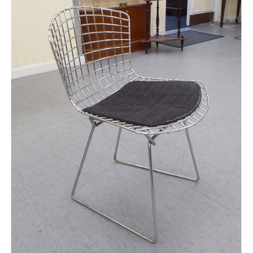 139 - A set of five Bertoia design chromium plated chairs with charcoal coloured, fabric covered cushion s... 