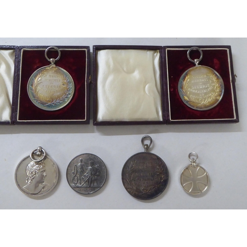 197 - White metal, bronze and other medallions and awards: to include a 1902 example