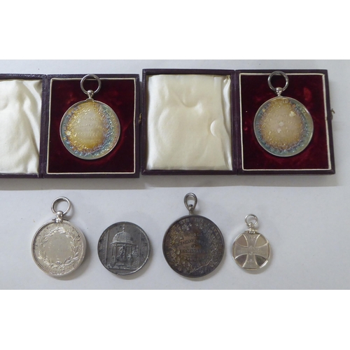 197 - White metal, bronze and other medallions and awards: to include a 1902 example