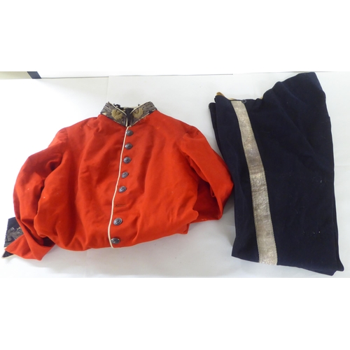 202 - Military collectables: to include a red fabric tunic with thistle embroidered cuffs and collar; and ... 