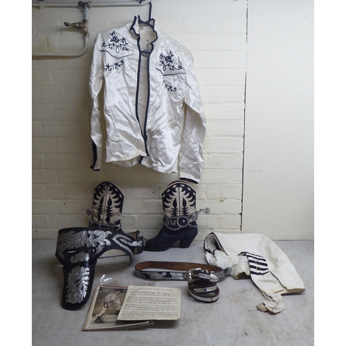 209 - A cowboy outfit with an accompanying photograph and sheet music