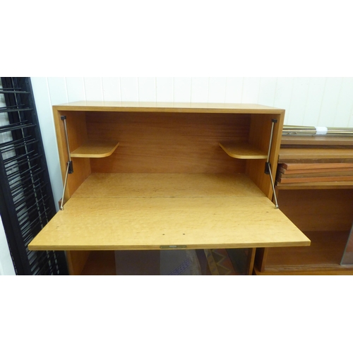 219 - A Staples Ladderax modular triple section livingroom unit, comprising an arrangement of cabinets and... 