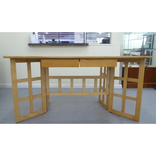 228 - A modern beech gateleg folding dining table  29