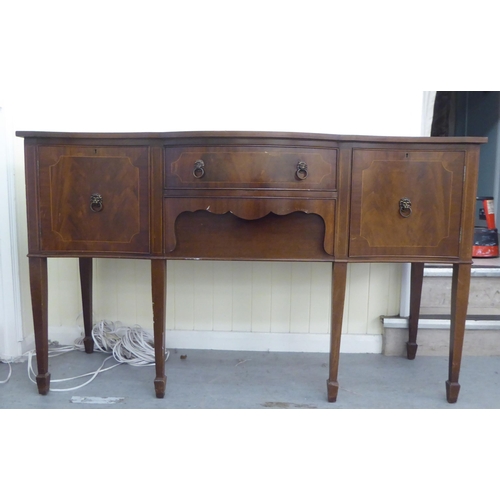 230 - A 20thC reproduction of a Georgian string inlaid mahogany breakfront bow sideboard, raised on square... 