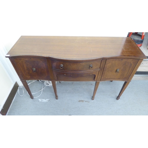 230 - A 20thC reproduction of a Georgian string inlaid mahogany breakfront bow sideboard, raised on square... 