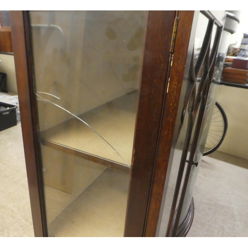 234 - A 1930s mahogany breakfront bow front display cabinet, raised on stubby cabriole legs, talon and bal... 