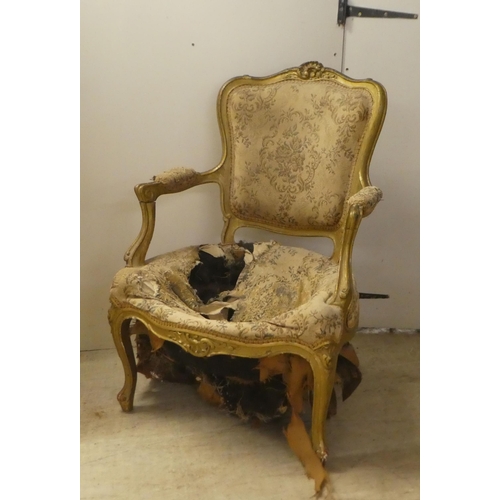 235 - An early 20thC French inspired gilt framed open salon chair, raised on cabriole forelegs