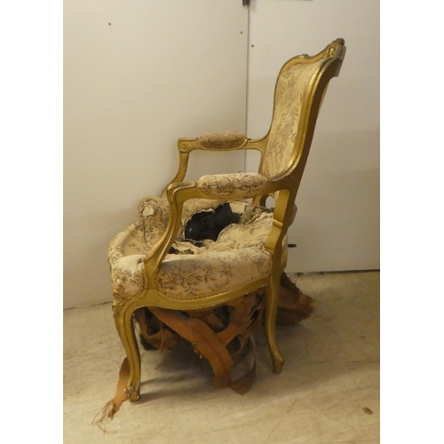 235 - An early 20thC French inspired gilt framed open salon chair, raised on cabriole forelegs