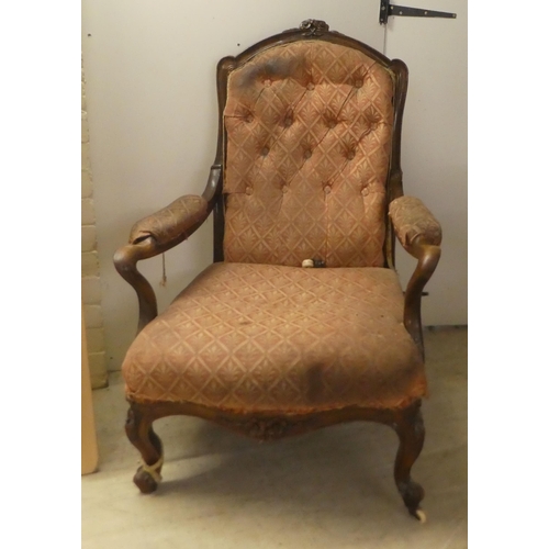 239 - A late Victorian mahogany showwood framed, open arm salon chair, raised on floral carved cabriole fo... 