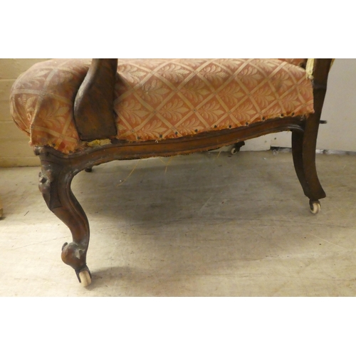 239 - A late Victorian mahogany showwood framed, open arm salon chair, raised on floral carved cabriole fo... 