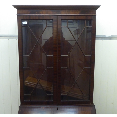 246 - A reproduction mahogany bureau bookcase, the upper section over a fall flap, over four graduated dra... 