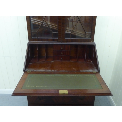 246 - A reproduction mahogany bureau bookcase, the upper section over a fall flap, over four graduated dra... 